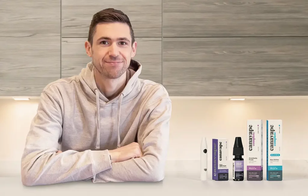 Canavape founder Ben next to some Canavape CBD products